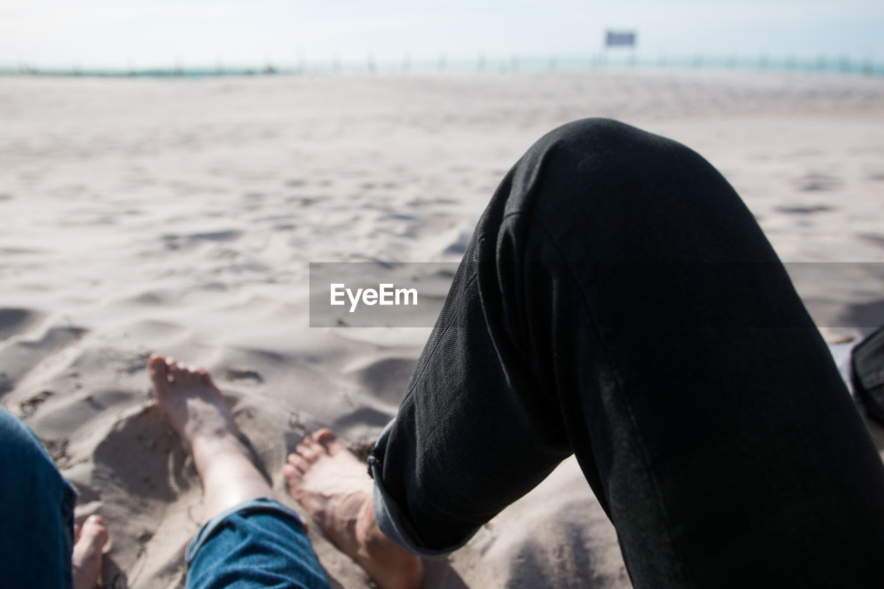 Low section of people relaxing at beach