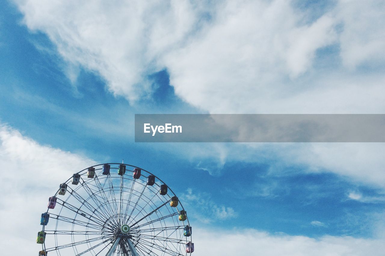 Low angle view of ferris wheel against sky