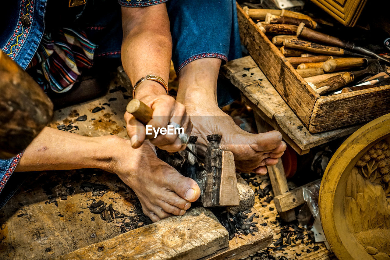 High angle view of artist carving wood