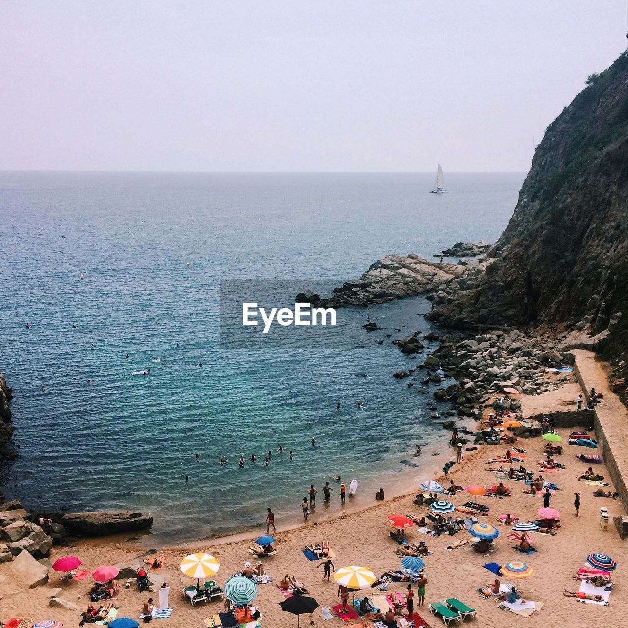 High angle view of people enjoying beach holiday against clear sky at tossa de mar