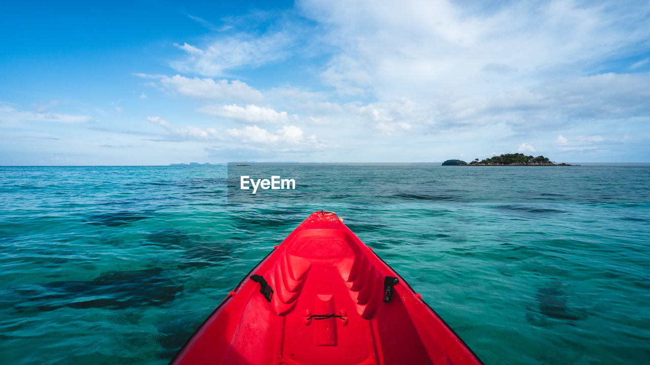 First person view of kayak heading to small island on turquoise sea. koh lipe island, thailand.