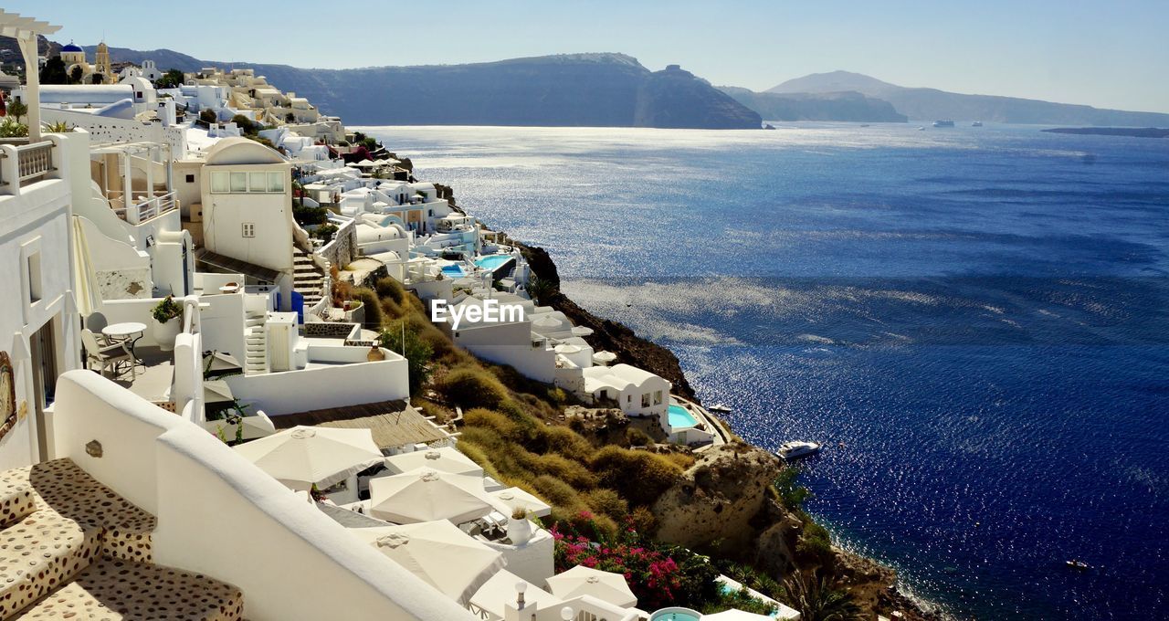 High angle view of buildings by sea against sky