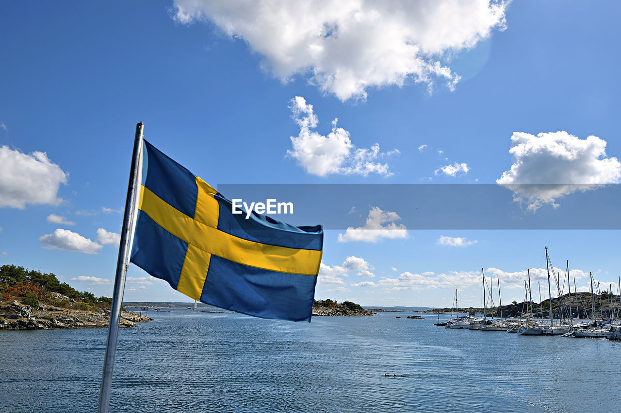 View of flags against blue sky