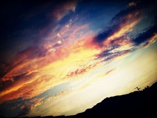 SCENIC VIEW OF LANDSCAPE AGAINST CLOUDY SKY AT SUNSET