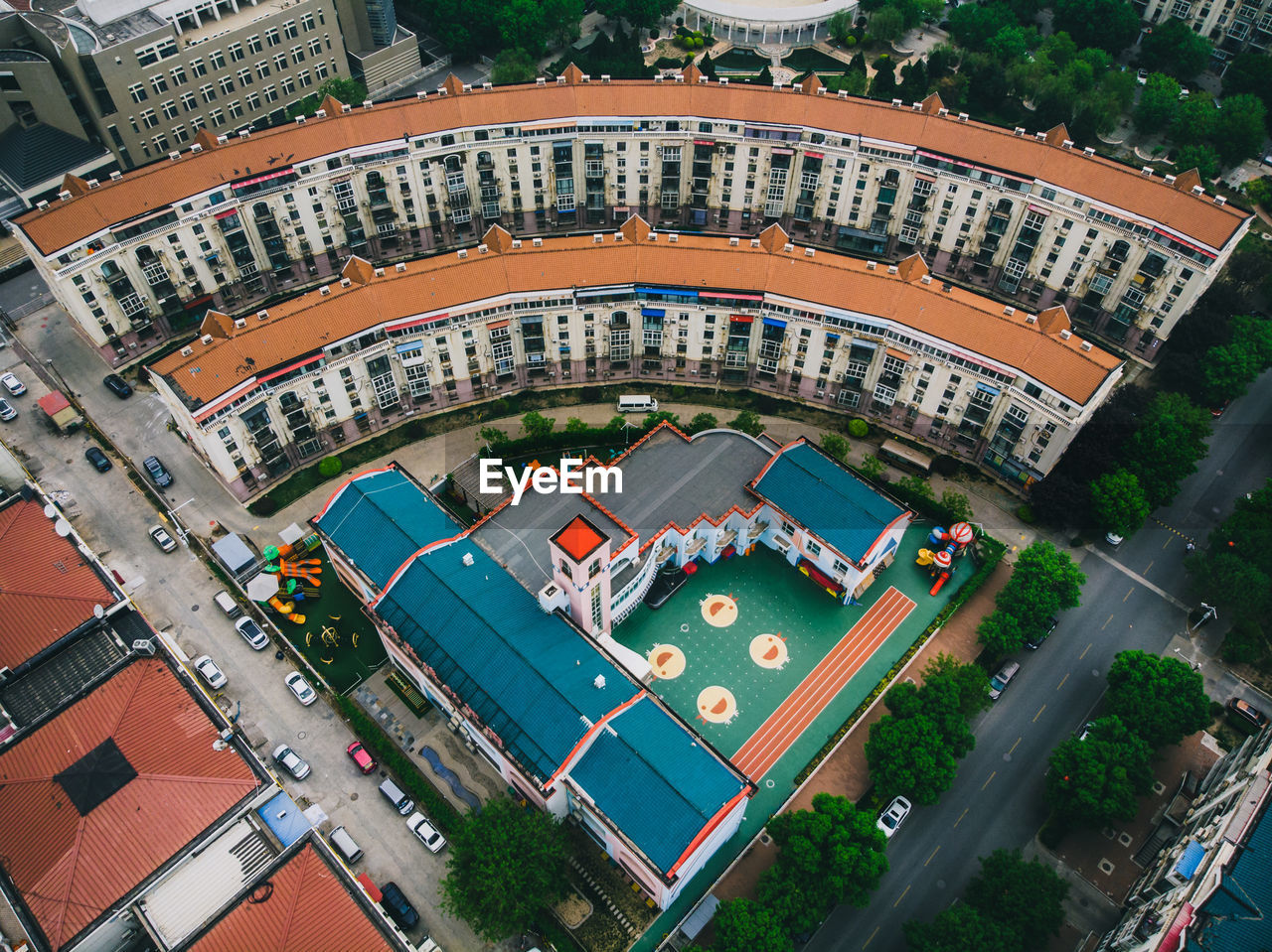 HIGH ANGLE VIEW OF SWIMMING POOL BY BUILDINGS