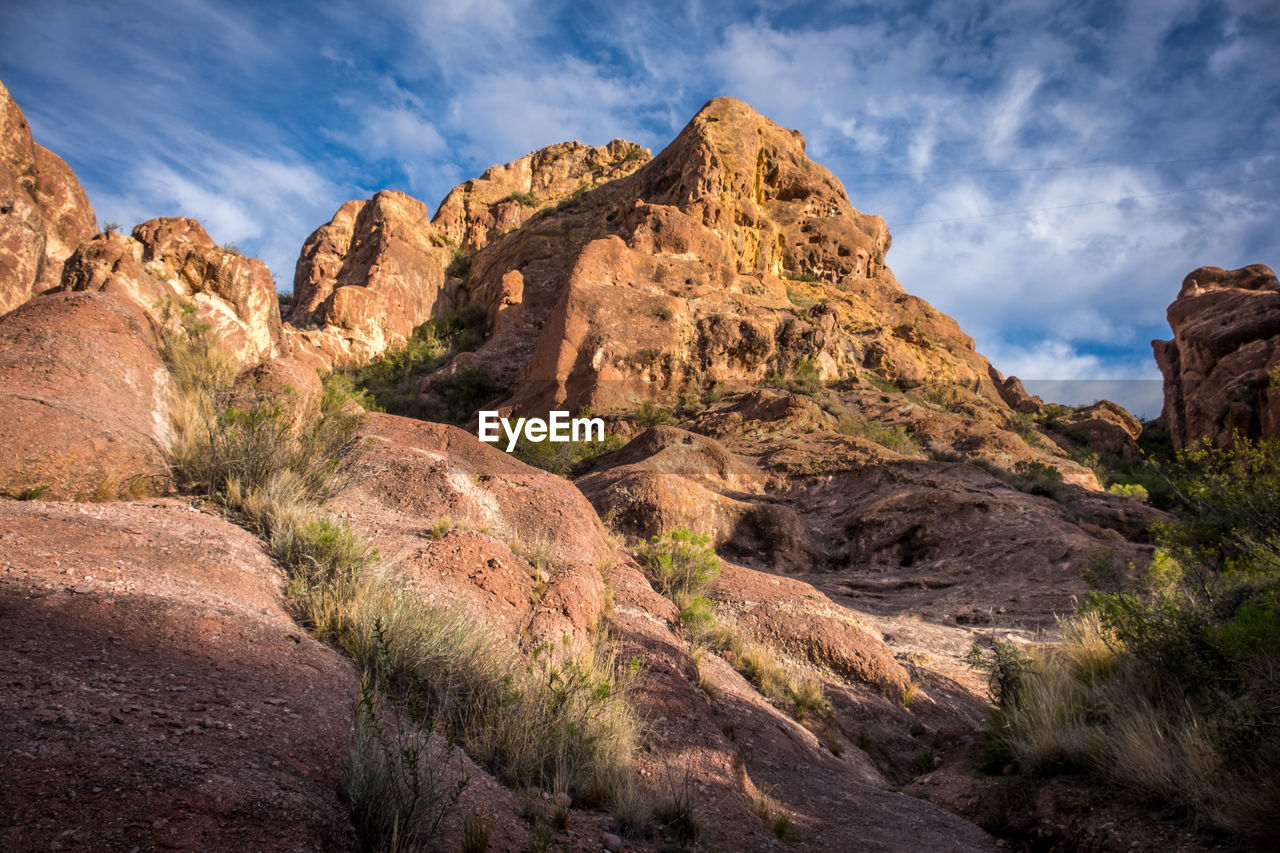 View of rock formation against cloudy sky