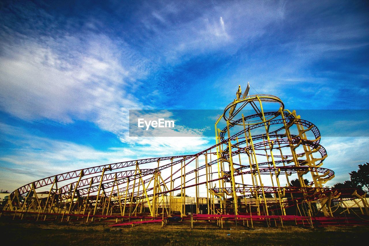 LOW ANGLE VIEW OF ROLLERCOASTER AGAINST SKY