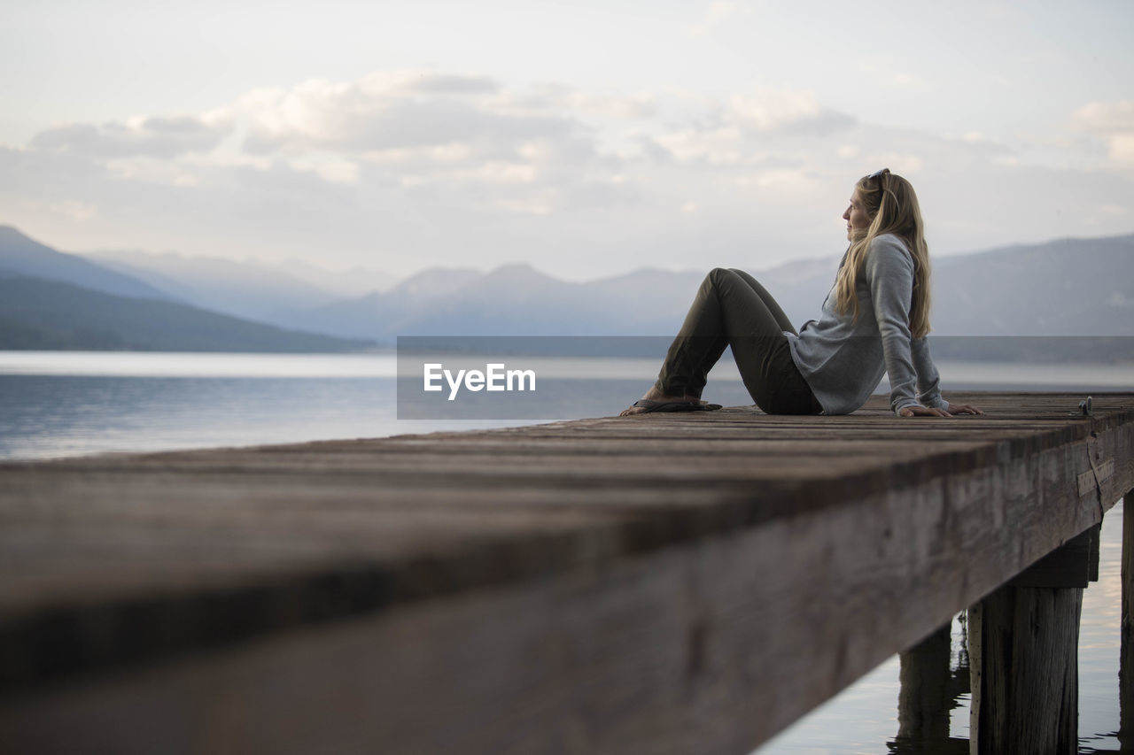 A woman enjoying an evening on the docks on hebgen lake.