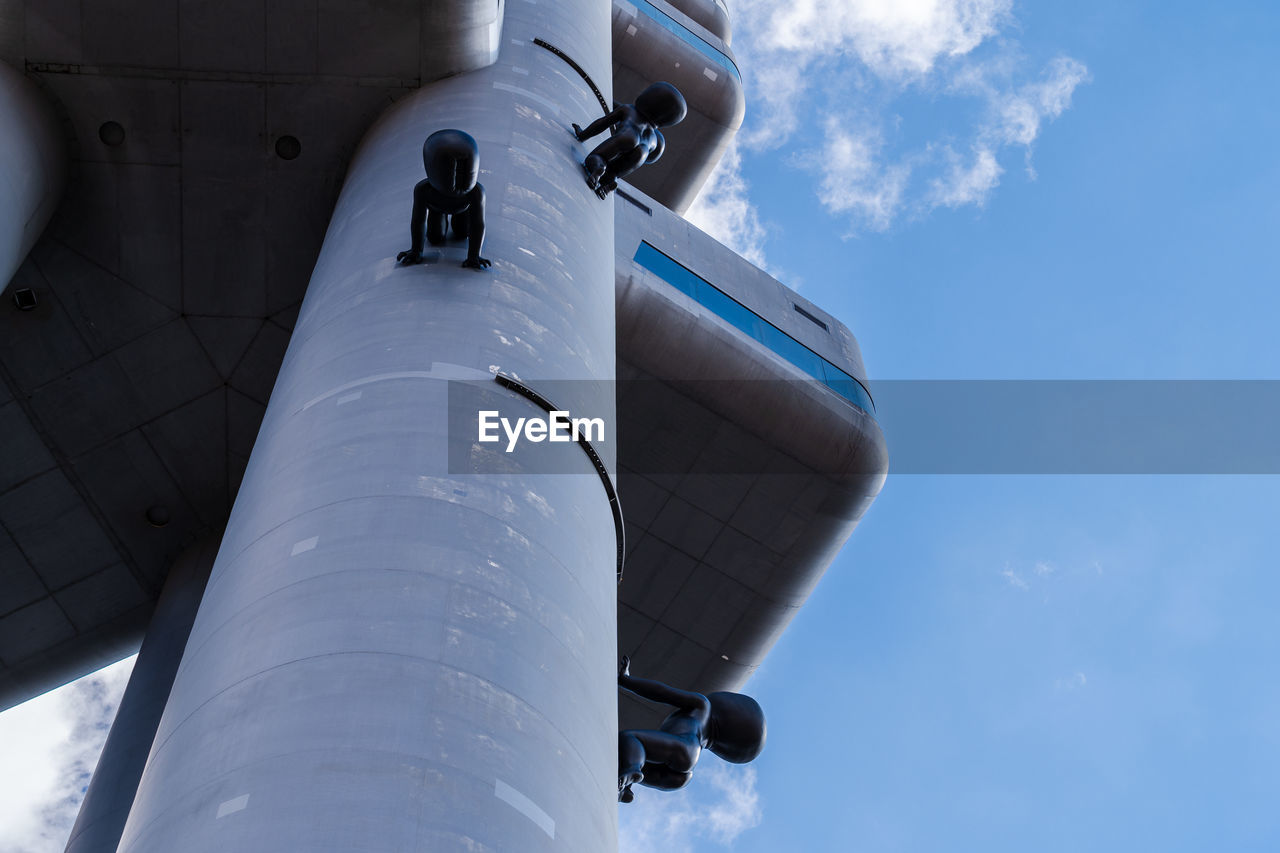 LOW ANGLE VIEW OF MAN AIRPLANE AGAINST SKY