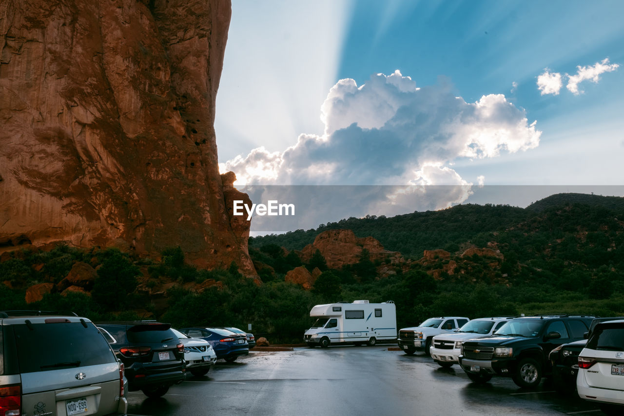 CARS ON ROAD AGAINST MOUNTAIN