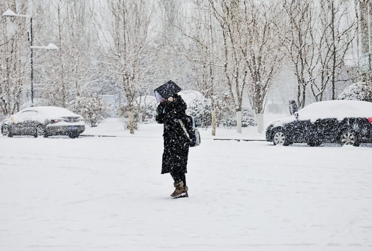 WOMAN STANDING IN SNOW