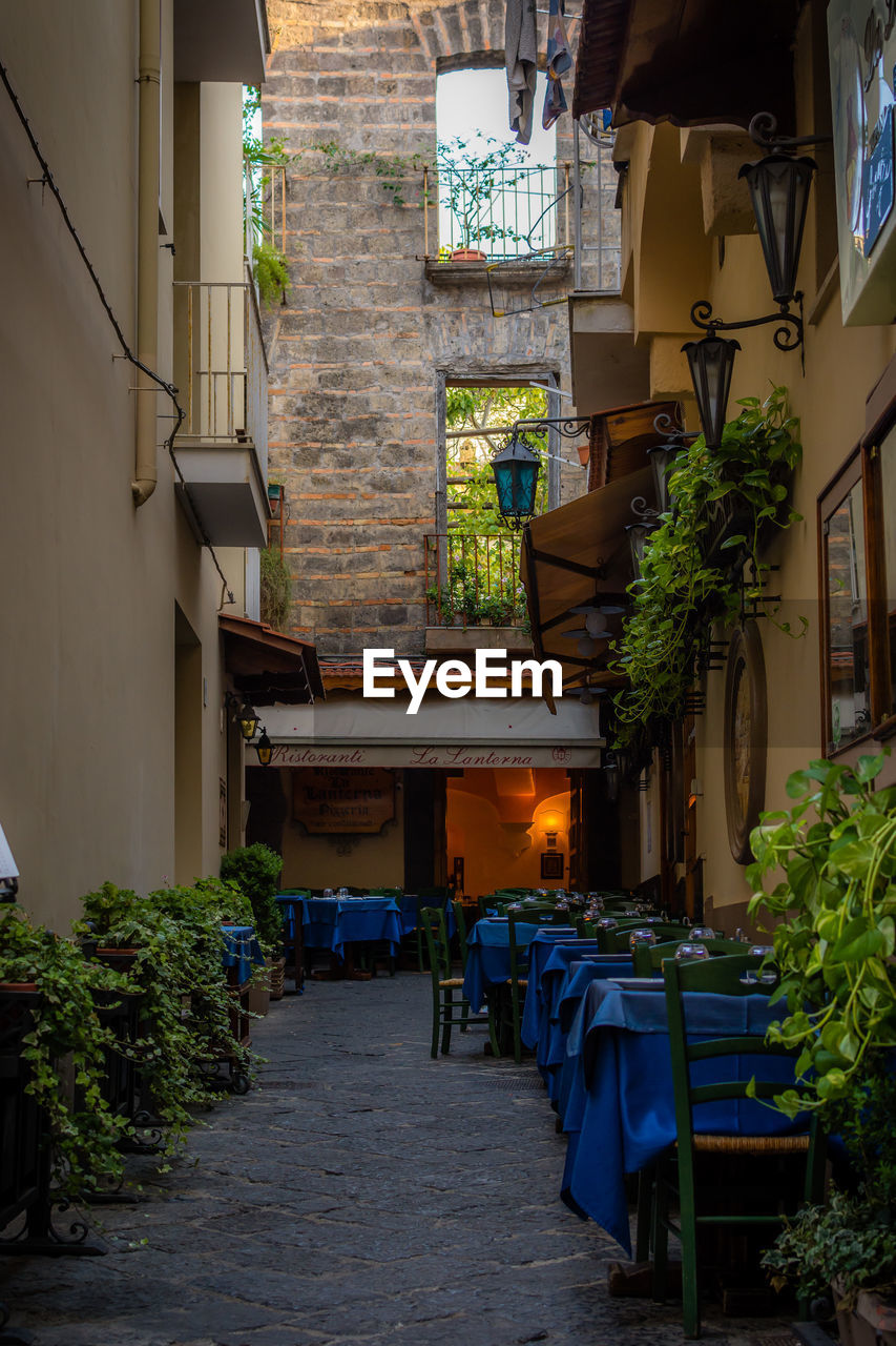 Tables and chairs arranged amidst buildings