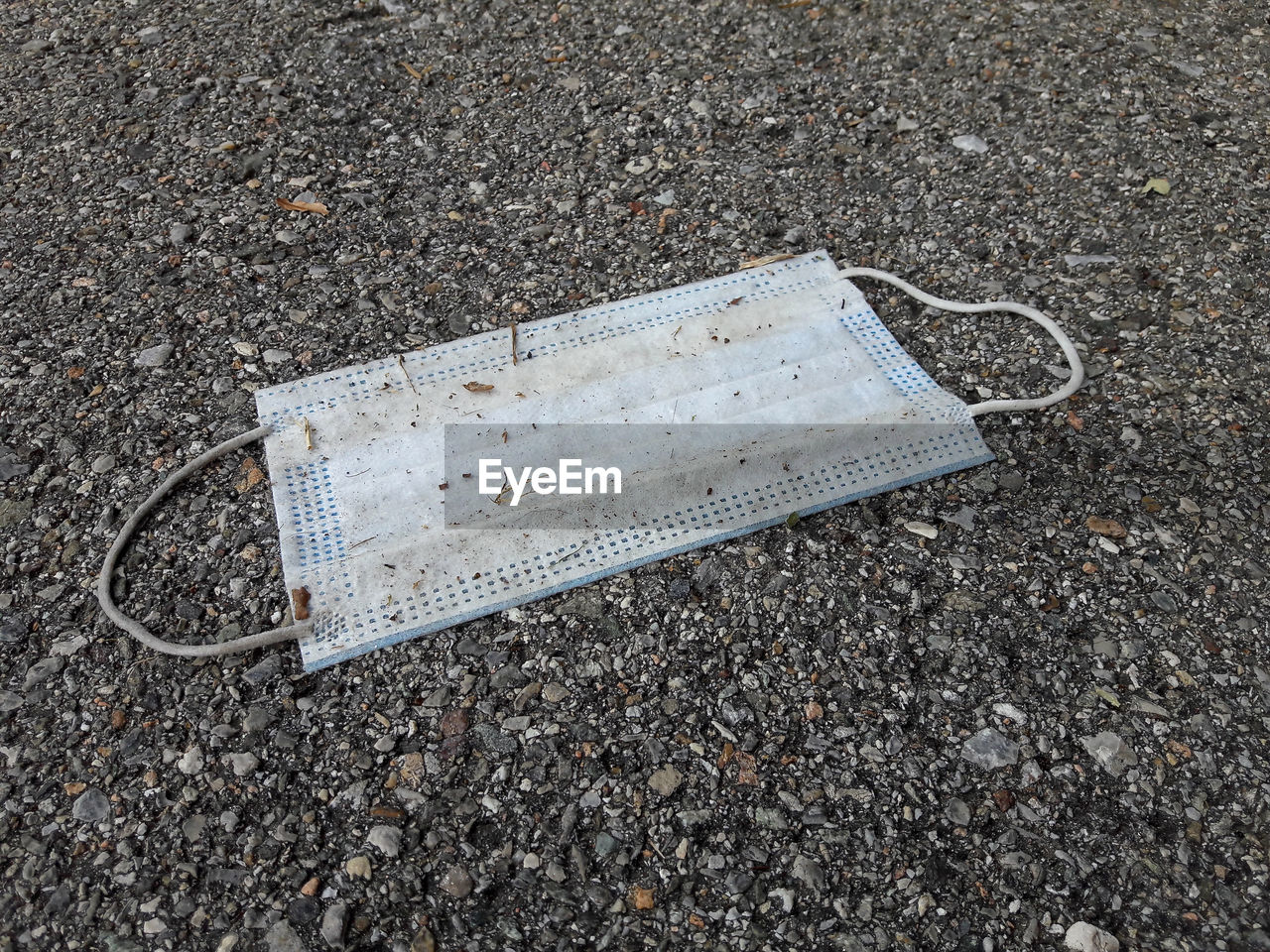 HIGH ANGLE VIEW OF ABANDONED CAR ON STREET