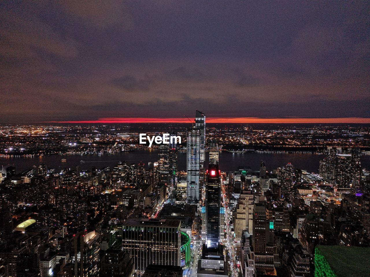 HIGH ANGLE VIEW OF CITY AGAINST CLOUDY SKY