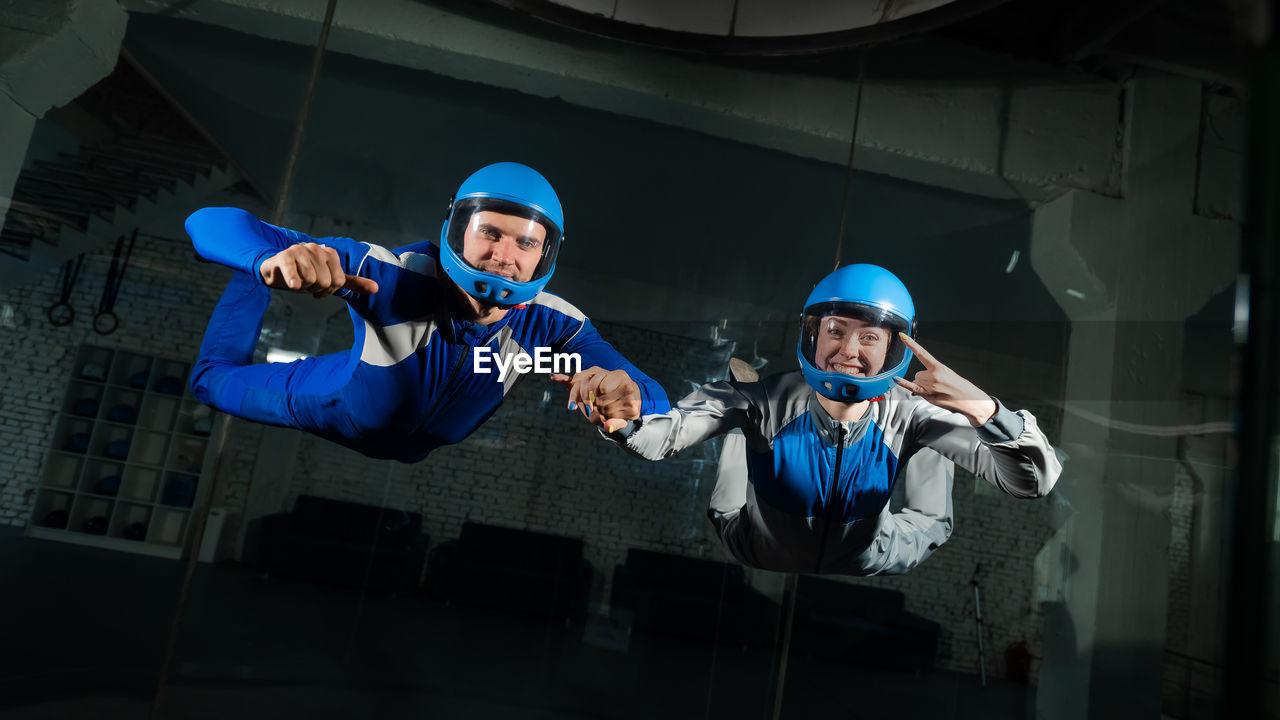 Portrait of man and woman doing indoors skydiving