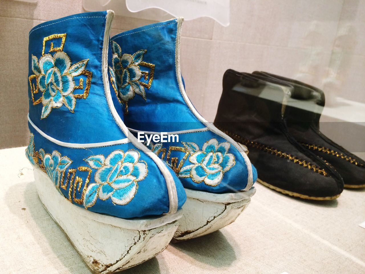 Close-up of traditional shoes on table in museum