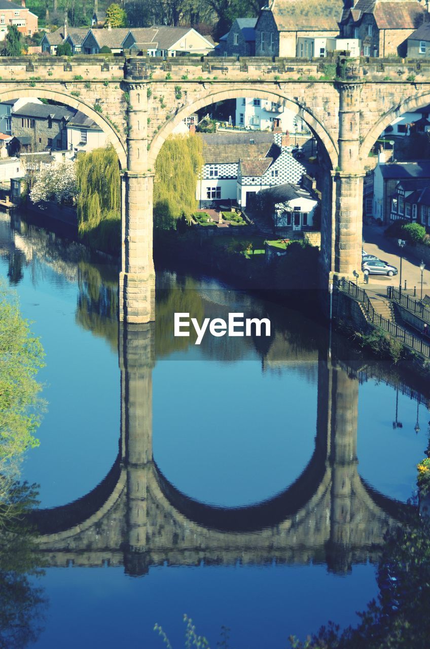 Reflection of old arch bridge over river nidd in knaresborough