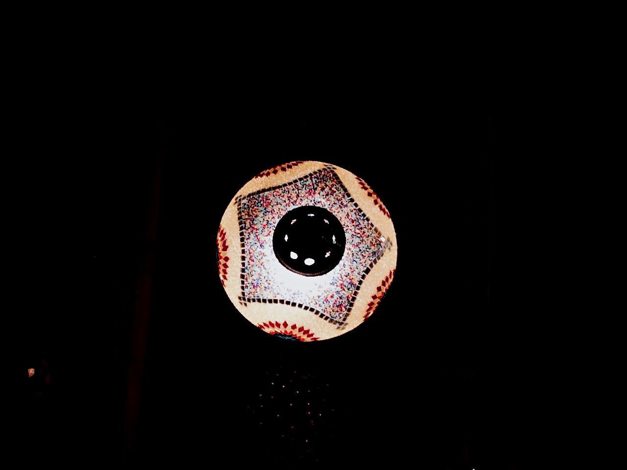 CLOSE-UP OF RED LIGHT OVER BLACK BACKGROUND