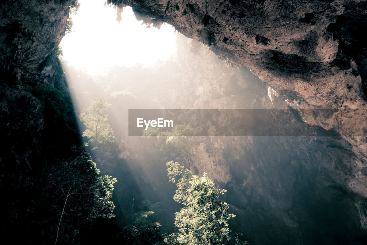 SCENIC VIEW OF WATERFALL AGAINST MOUNTAINS