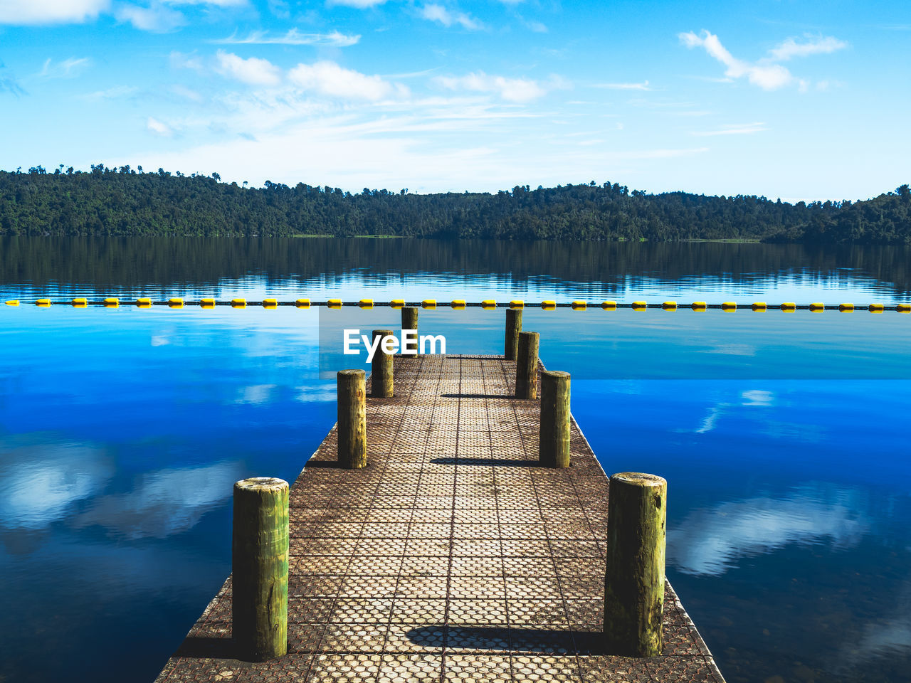 reflection, water, sky, lake, scenics - nature, nature, beauty in nature, tranquility, tranquil scene, reservoir, pier, jetty, cloud, tree, landscape, blue, wood, body of water, environment, no people, land, travel destinations, forest, travel, morning, dock, outdoors, mountain, plant, shore, non-urban scene, horizon, architecture, idyllic, summer, day, dusk, trip, vacation, tourism, holiday, sunlight, bay