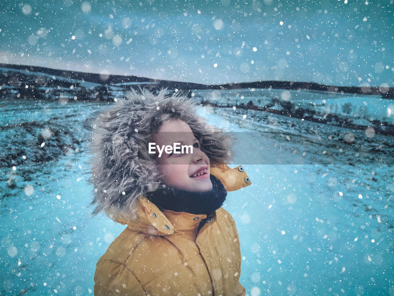 Smiling girl looking up during winter