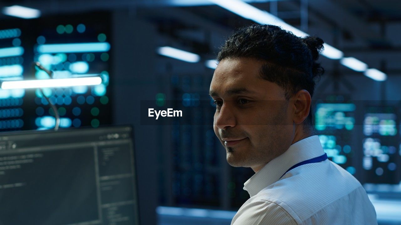 side view of young man looking at airport