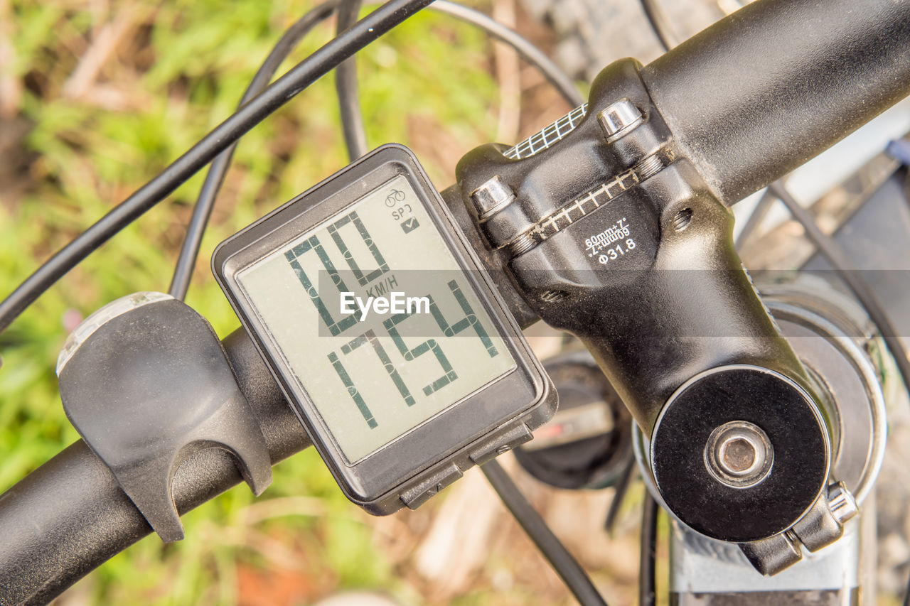 Black mountain bike handlebar with wireless bike computer close-up. top view