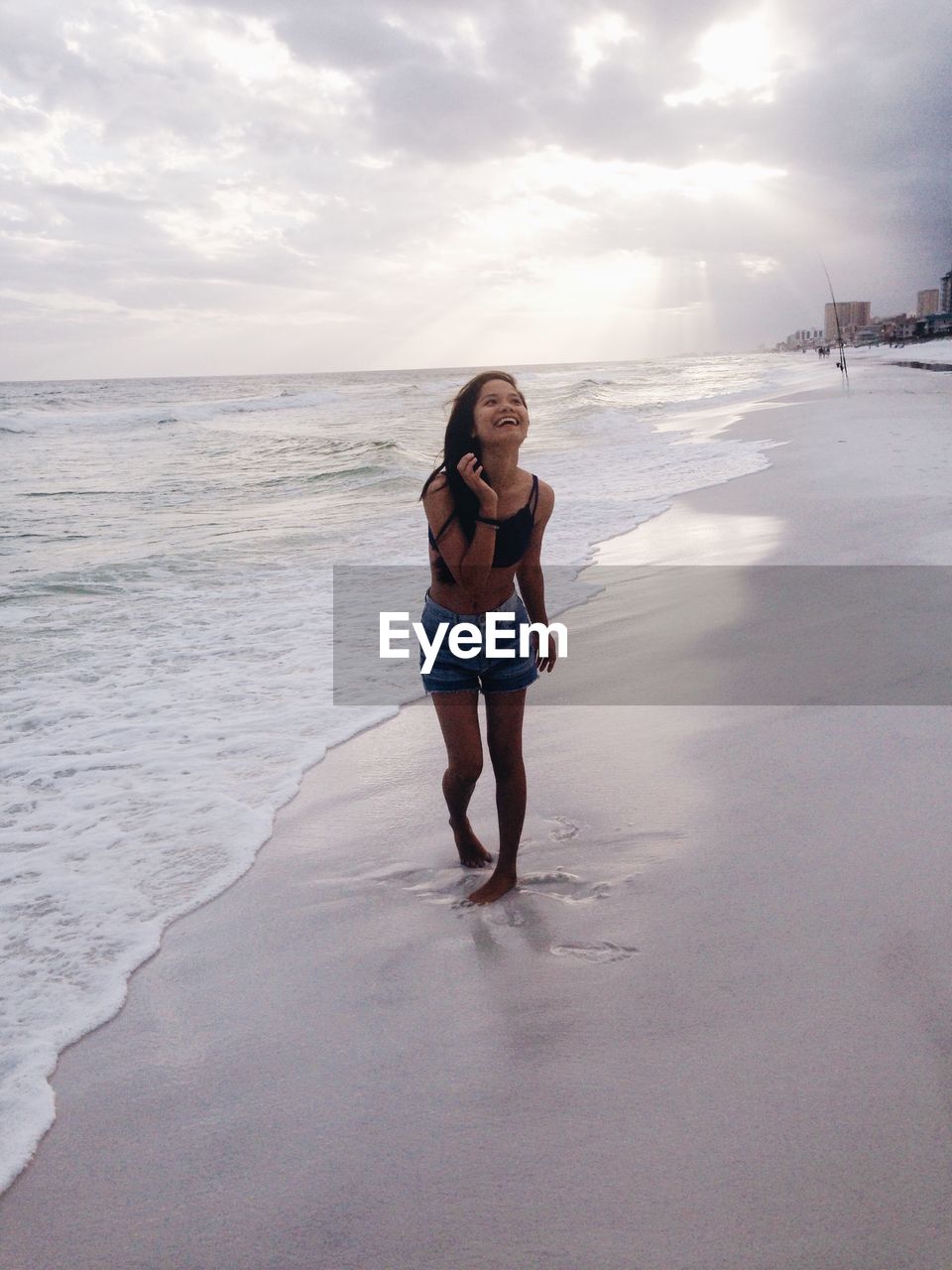 WOMAN STANDING ON BEACH