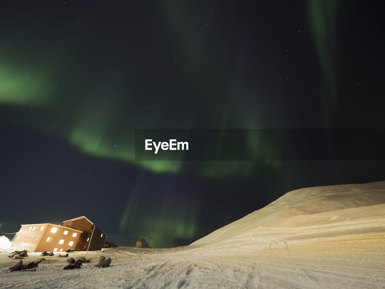 Scenic view of illuminated landscape against sky at night