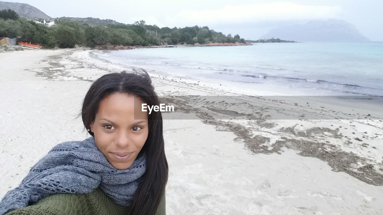 Young woman standing on shore at beach in porto istana