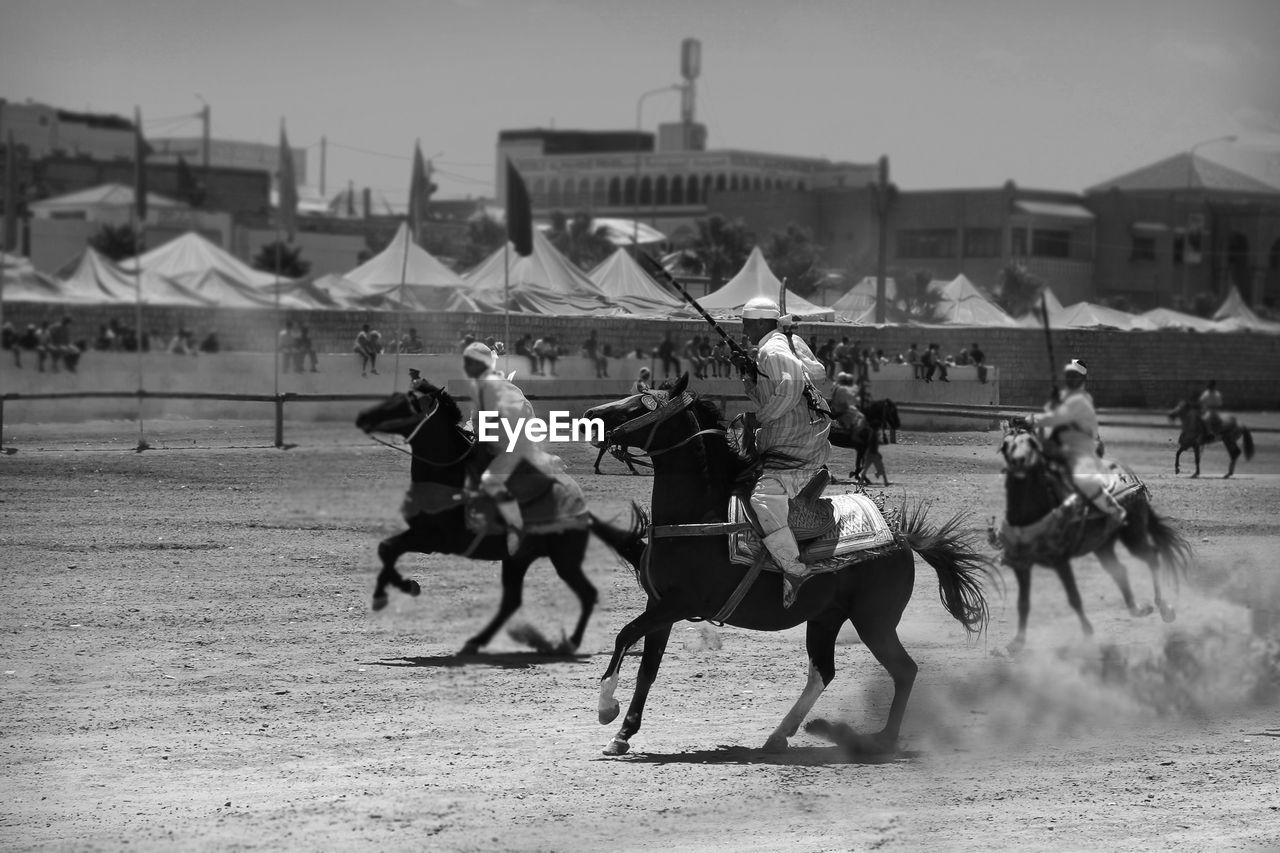 People riding horse during race