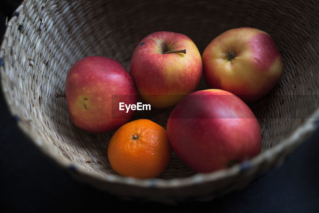 CLOSE-UP OF APPLE IN BASKET