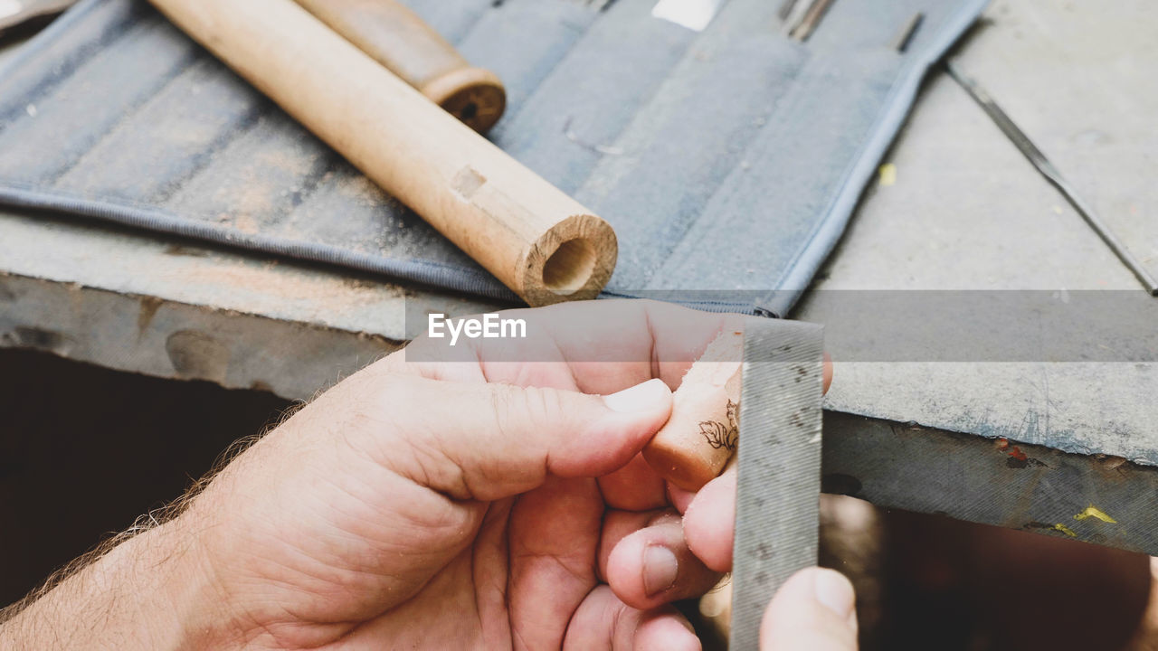 Close-up of hand working in workshop