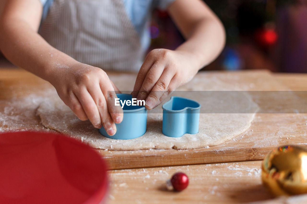 Midsection of boy preparing food on cutting board