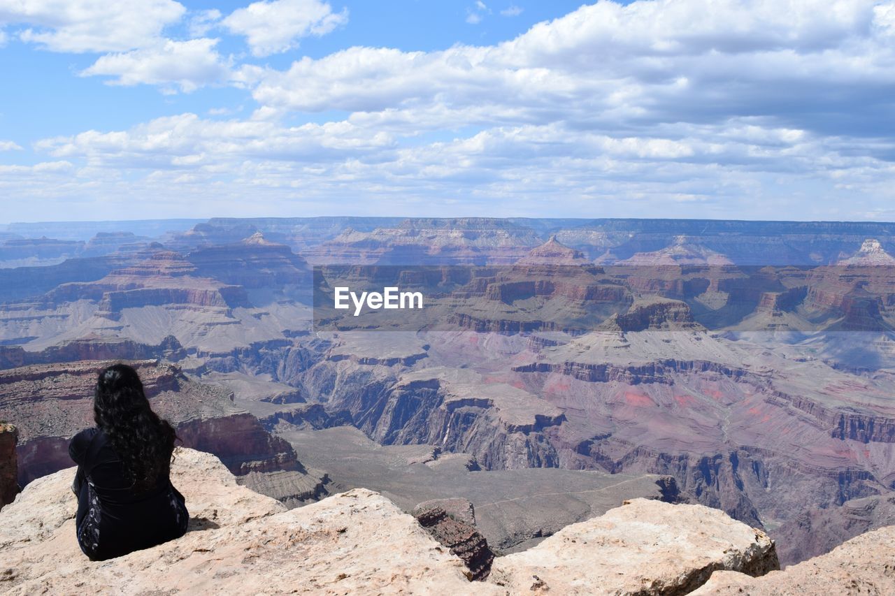 Rear view of woman on south rim of grand canyon in midday sun