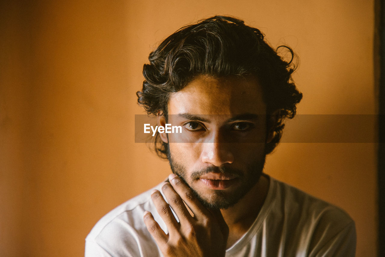 Portrait of young man against colored background