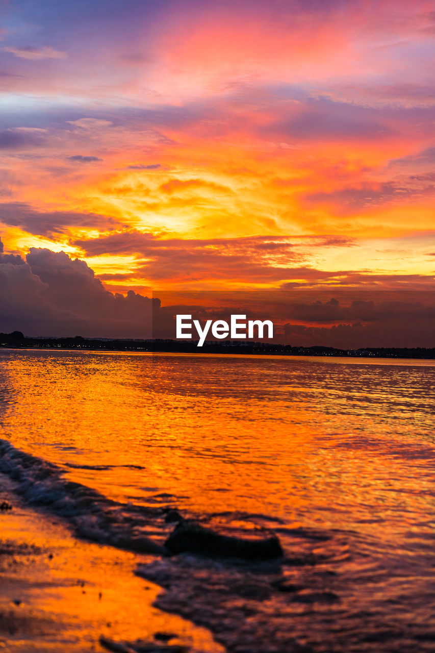 SCENIC VIEW OF SEA AGAINST ROMANTIC SKY DURING SUNSET