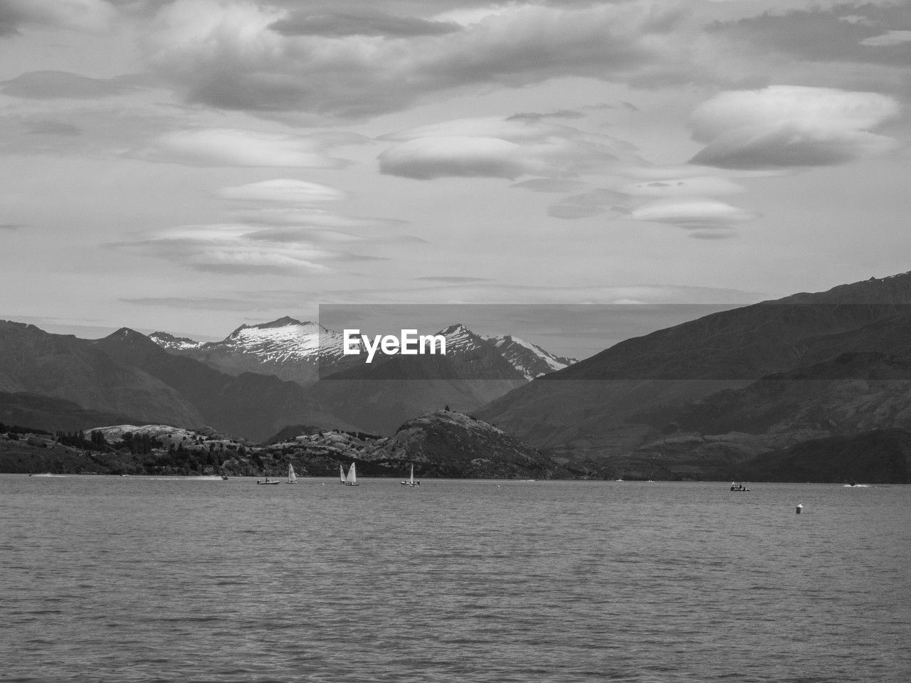 mountain, mountain range, water, scenics - nature, sky, cloud, environment, beauty in nature, black and white, nature, lake, landscape, monochrome, monochrome photography, tranquil scene, no people, tranquility, travel destinations, horizon, land, travel, snow, outdoors, day, architecture, snowcapped mountain, tourism, cold temperature, non-urban scene, holiday