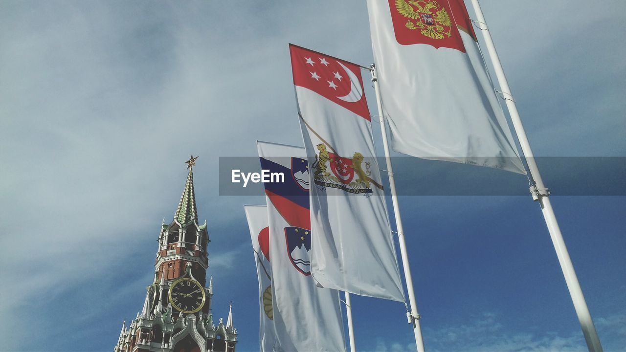 LOW ANGLE VIEW OF FLAGS HANGING ON POLE