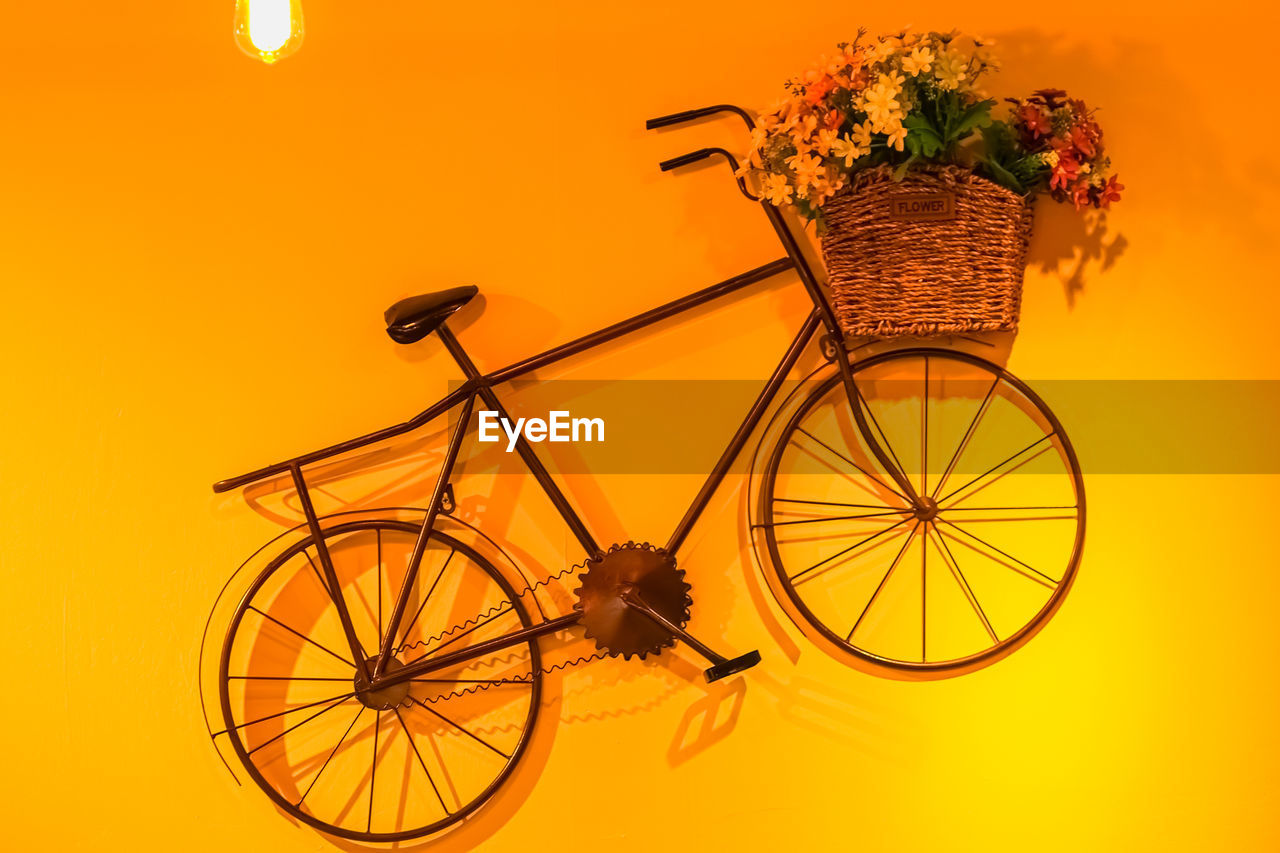 BICYCLE AGAINST YELLOW WALL