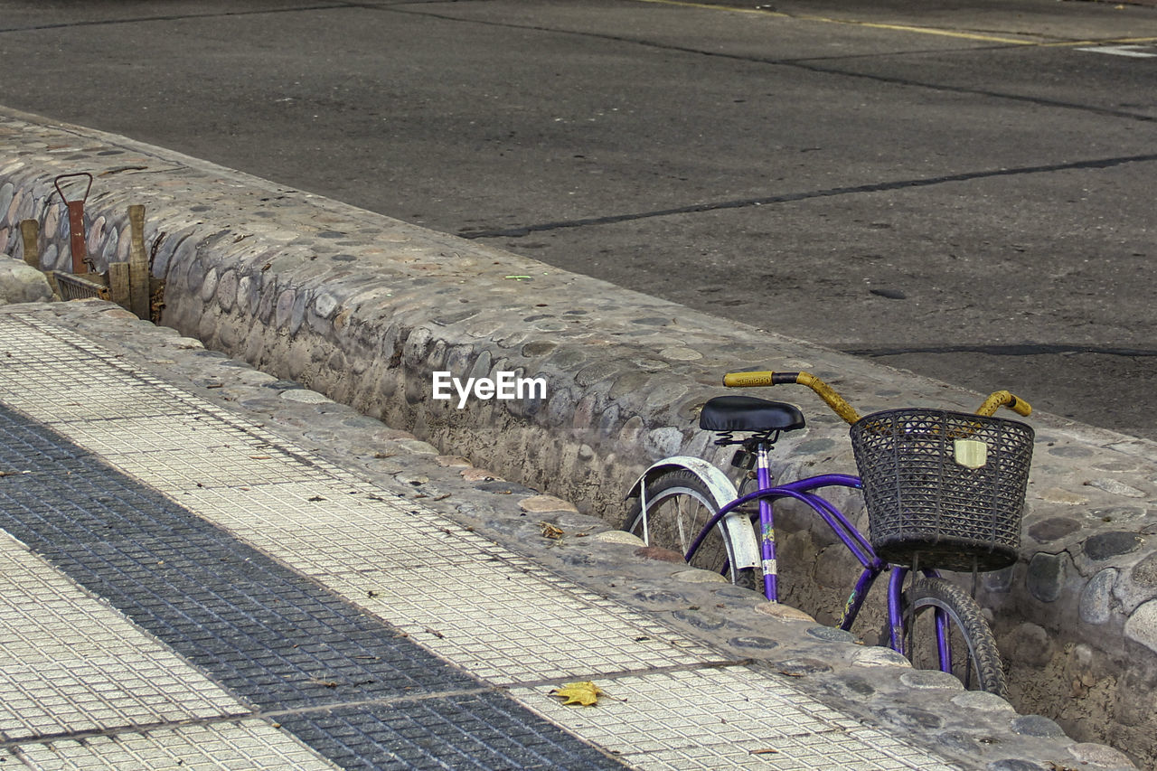 BICYCLE PARKED ON COBBLESTONE