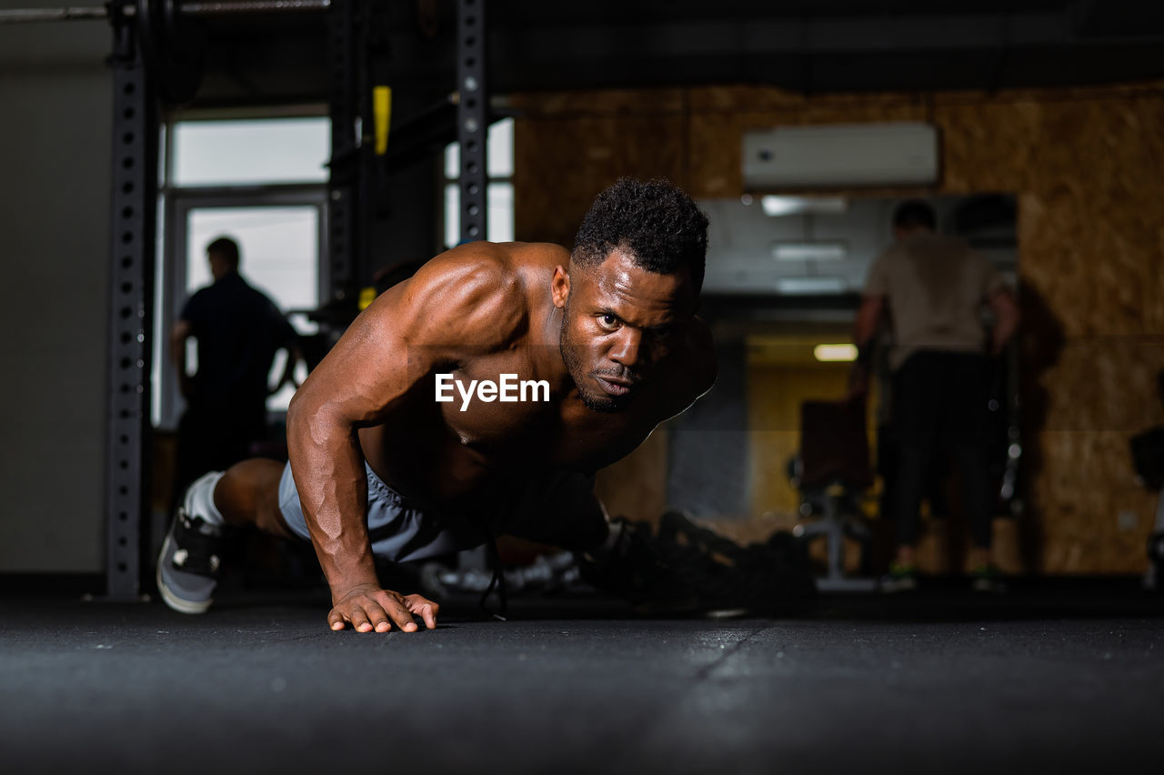 side view of man exercising in gym