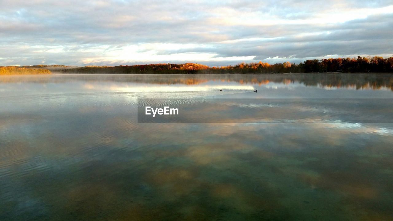 Scenic view of lake against cloudy sky