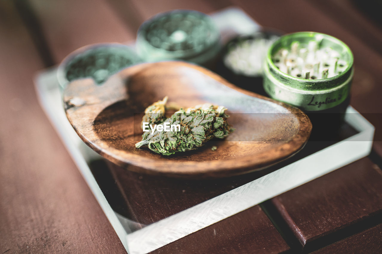 High angle view of marijuana on glass plate at table