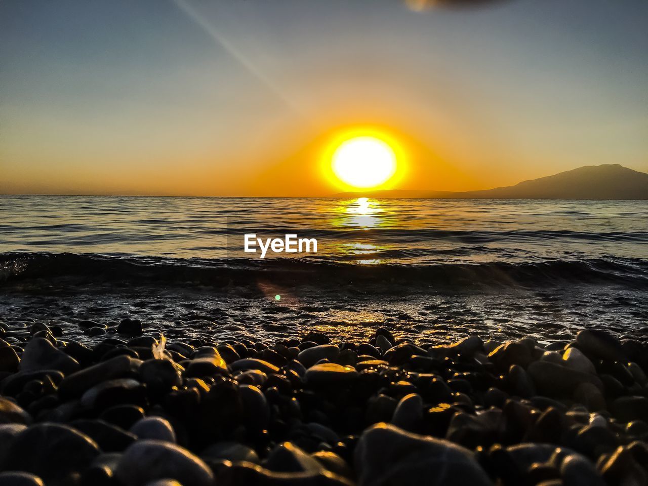 SCENIC VIEW OF BEACH DURING SUNSET