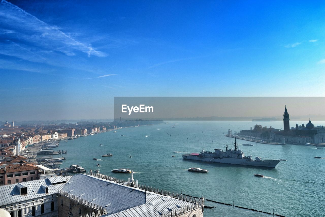 Cityscape by grand canal against sky