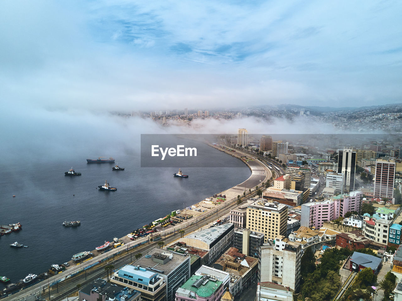 High angle view of buildings by sea against sky