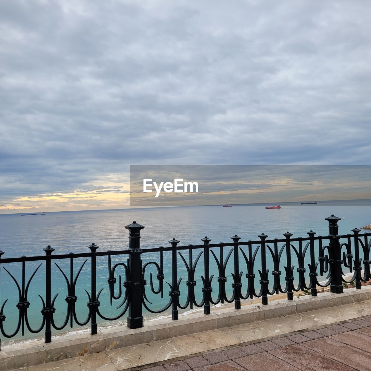 sky, water, sea, cloud, railing, nature, architecture, pier, walkway, coast, scenics - nature, horizon over water, beach, beauty in nature, horizon, tranquility, no people, footpath, land, transportation, travel destinations, sunset, boardwalk, ocean, tranquil scene, outdoors, city, travel, built structure, tourism, wood, shore, day, vacation, environment, landscape, idyllic, fence