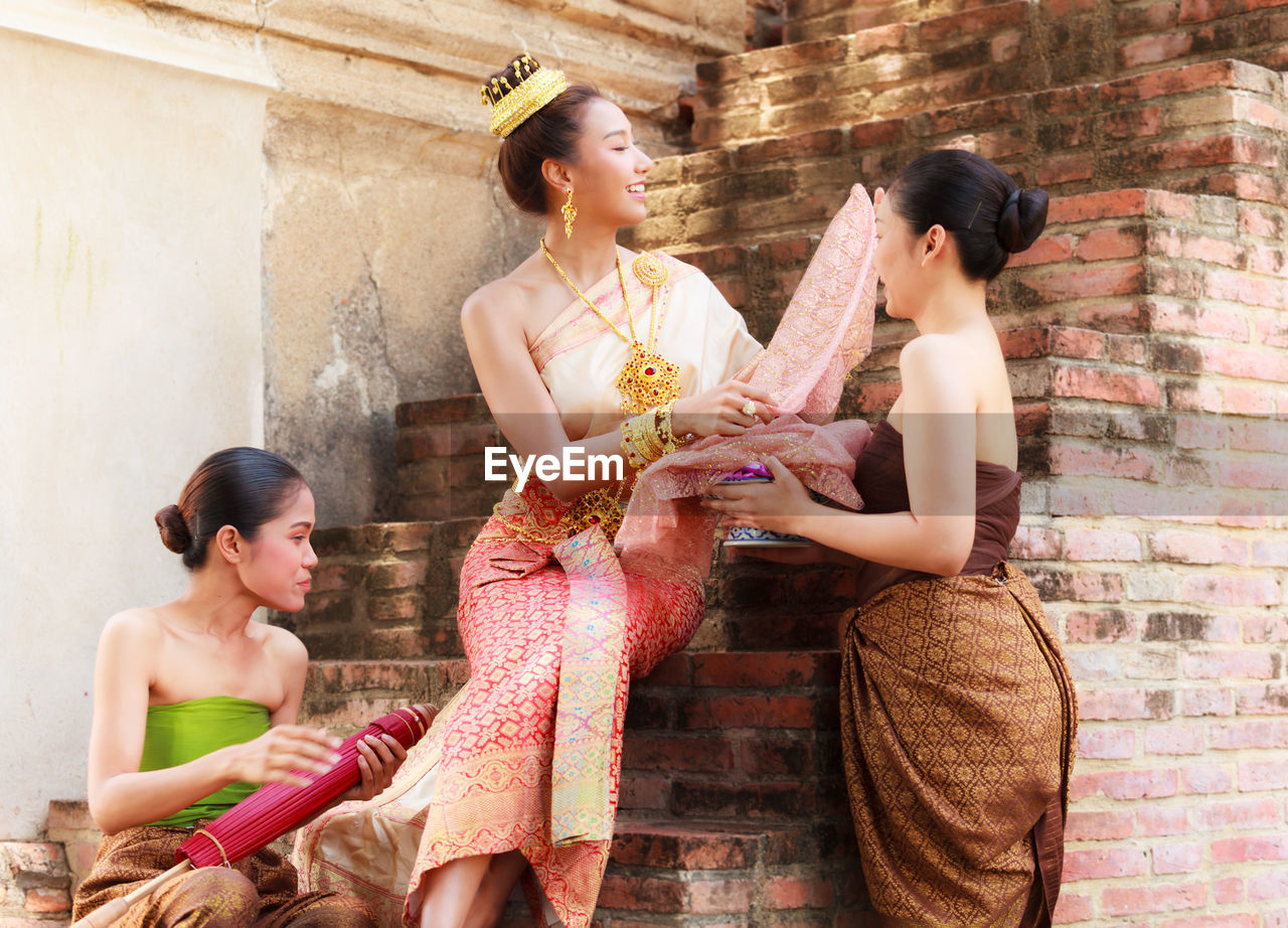 Young female models wearing traditional clothing at brick steps