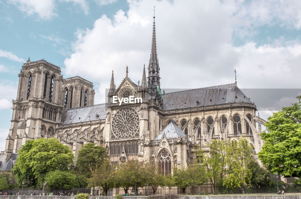 Panoramic view of notre dame and trees against sky